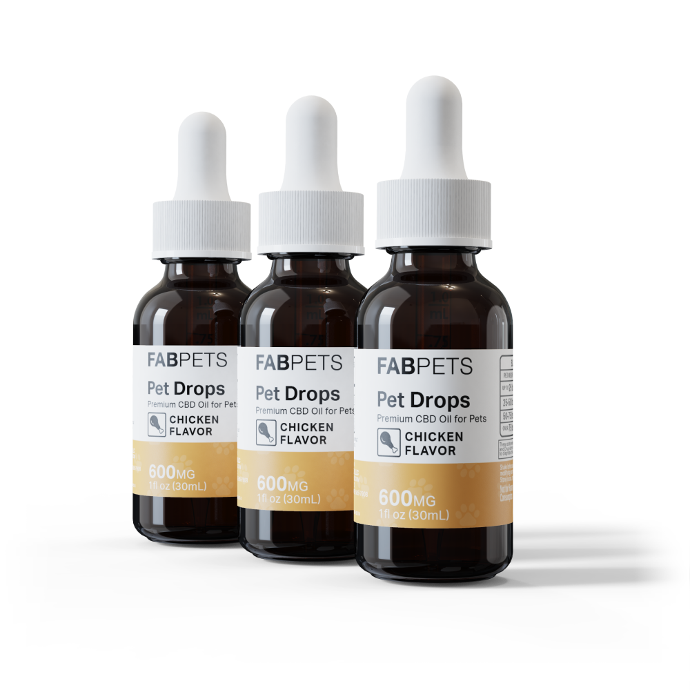 Three amber glass dropper bottles of FABPETS Pet Drops Premium CBD Oil for Pets with white caps and orange-and-white labels reading 'Chicken Flavor, 600MG, 1 fl oz (30 mL),' arranged in a staggered row on a white background.