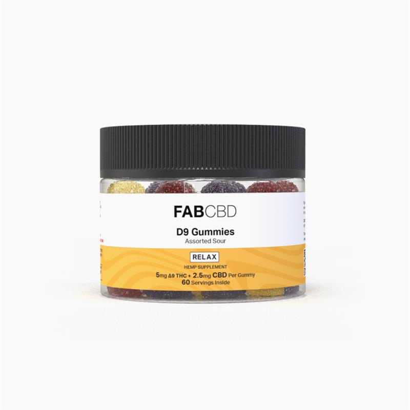 A clear plastic jar with a ribbed black lid filled with sugar-coated, multi-colored gummies standing upright against a white background. The front label features FAB CBD branding for D9 Gummies in "Assorted Sour" flavor with a yellow "RELAX HEMP SUPPLEMENT" banner displaying key specifications: "5mg Δ9 THC + 2.5mg CBD Per Gummy" and "60 Servings Inside."