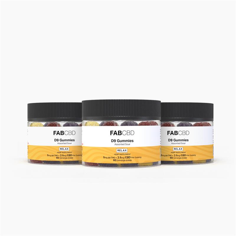 Three clear plastic jars with ribbed black lids filled with sugar-coated, multi-colored gummies standing side-by-side in a row against a pure white background. Each front label features FAB CBD branding for D9 Gummies in "Assorted Sour" flavor with a yellow "RELAX HEMP SUPPLEMENT" banner displaying identical product specifications: "5mg Δ9 THC + 2.5mg CBD Per Gummy" and "60 Servings Inside."