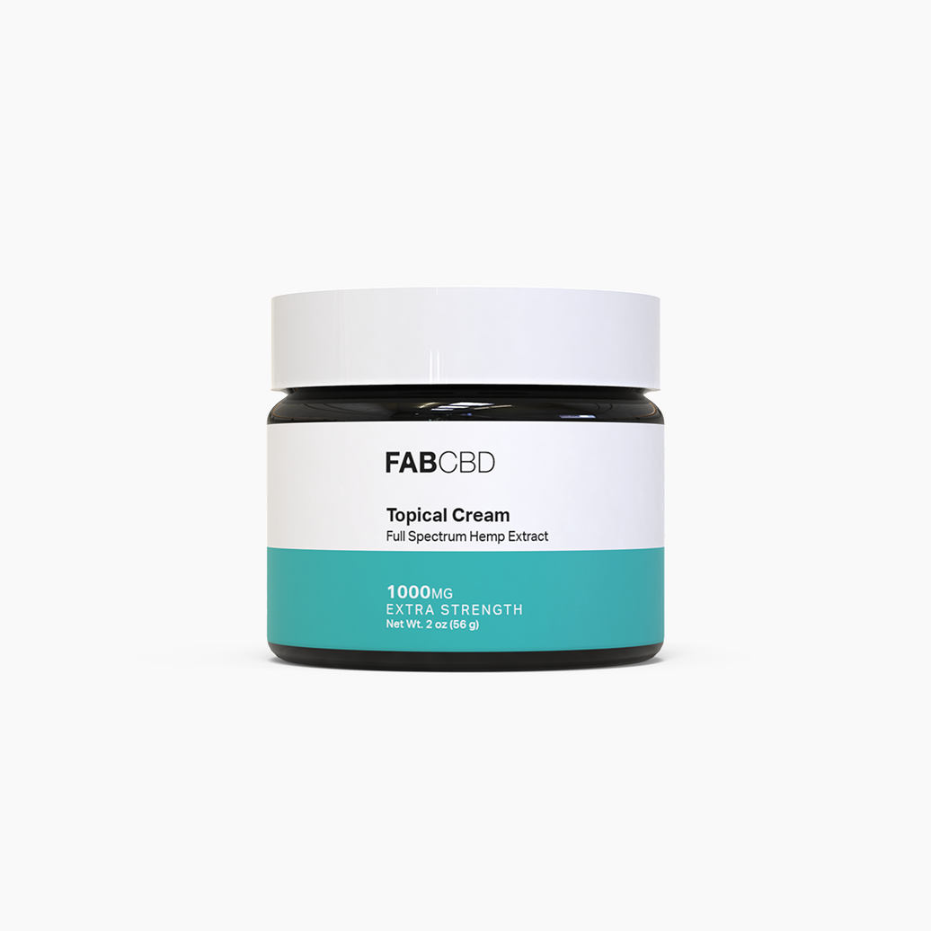 FABCBD Topical Cream dark amber glass jar with a white screw-top lid standing upright against a plain white background. The front white and teal label details the product as a "Full Spectrum Hemp Extract" with the specifications: "1000MG", "EXTRA STRENGTH", and "Net Wt. 2 oz (56 g)."
