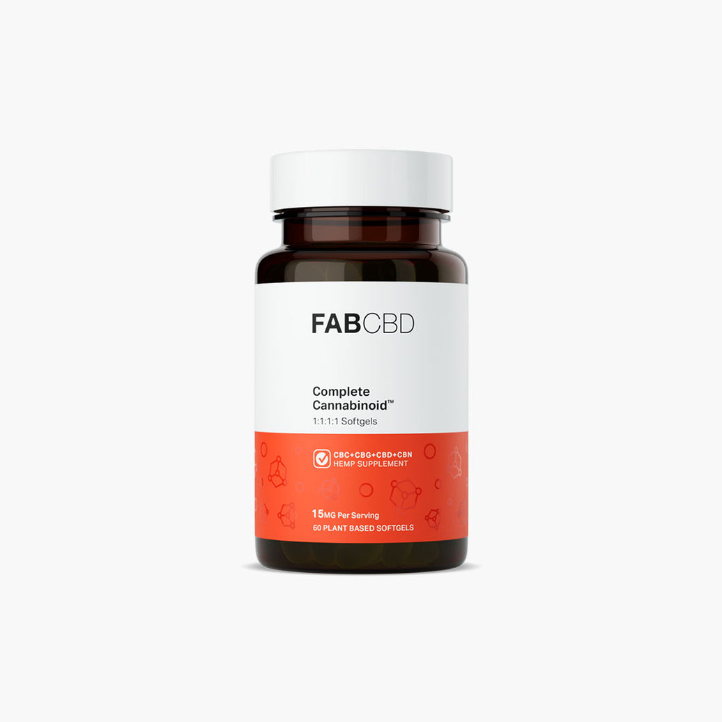 An amber glass supplement bottle of FAB CBD Complete Cannabinoid™ 1:1:1:1 Softgels standing upright against a pure white background. The bottle features a white and bright orange label displaying product specifications, including "CBC+CBG+CBD+CBN HEMP SUPPLEMENT," a potency of "15MG Per Serving," and a count of "60 PLANT BASED SOFTGELS."